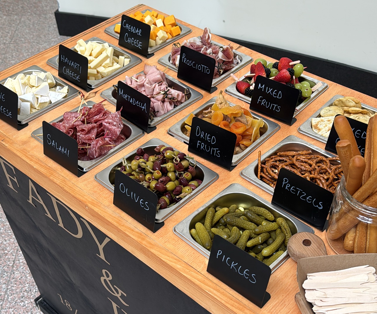 249 Bitez charcuterie cart trays with hand-chalked labels.